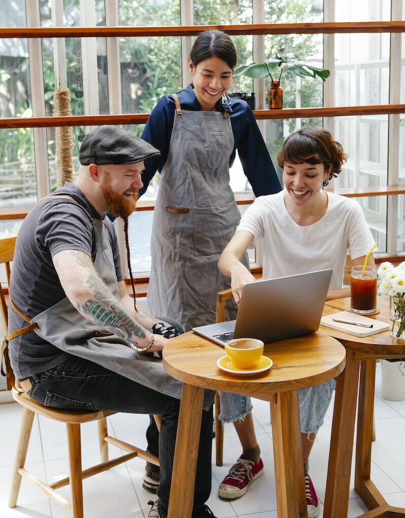 Colleagues working on netbook in cafe